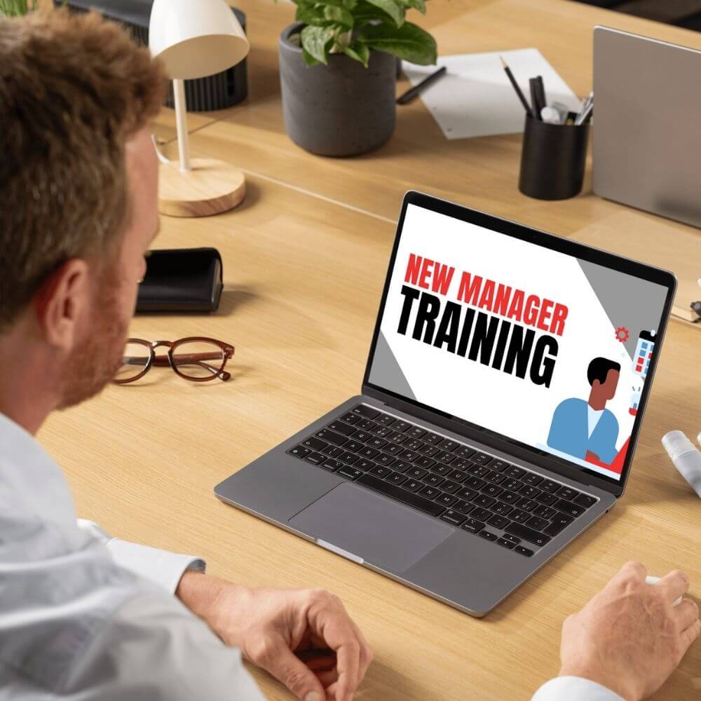 man working on new manager training on laptop